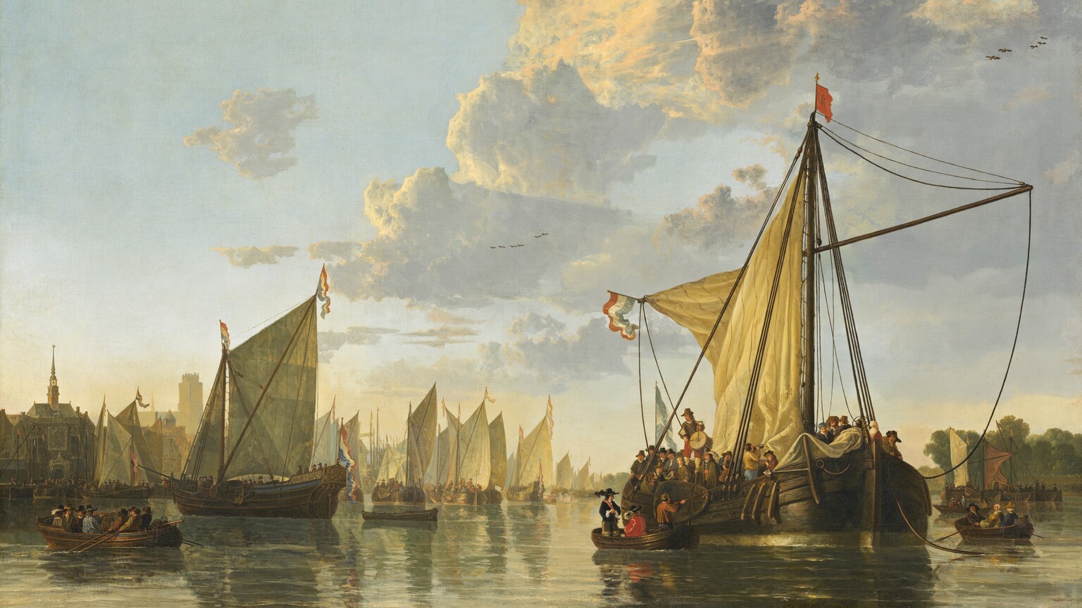 A fleet of ships gathers in a river lined by trees and buildings in this horizontal painting. The horizon is low, less than a quarter of the way up the composition, and the immense pale blue sky above is filled with clouds with golden tops above dove-gray undersides. The river spans the width of the painting and is congested with boats and ships, many festooned with red, white, and blue flags and banners. The vessels are crowded with people, mostly men wearing hats and black or brown garments. A ship to our right is closest to us and is the largest in the composition. A rowboat has pulled up to the side of the ship, and is occupied by a seated man wearing crimson red and a standing man wearing black. Another man, wearing brown, pulls the rowboat closer to the ship. Amid the densely packed deck over the rowboat, a musician plays a drum while another drinks from a flagon. Ships with unfurled sails, rowboats, and ferries fill the river behind and around the large ship. Churches and buildings are clustered along the riverbank to the left and trees line the river to the right.