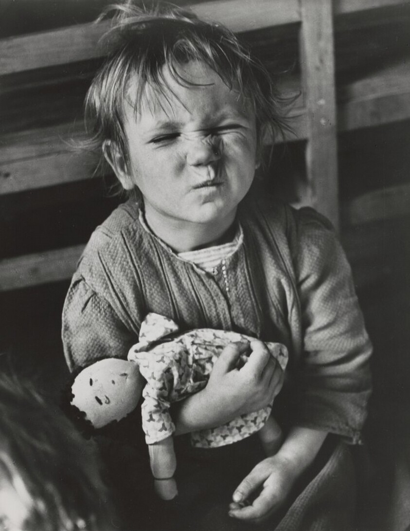 A child from the Sudeten region of Czechoslovakia plays with a homemade doll, Vienna, Austria