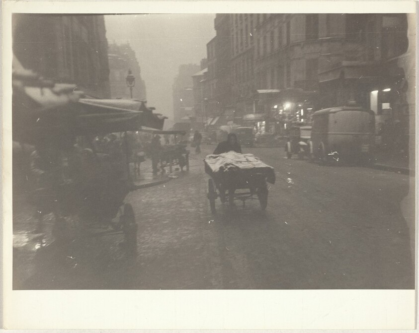 Vendor pushing cart in rain, Paris