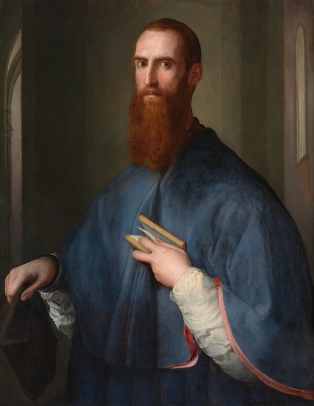 A light-skinned man with short, auburn-brown hair and a long beard is shown from the hips up, his chest and sloping shoulders covered by a muted cobalt-blue cape in this vertical portrait painting. His body is angled to our left and he looks at us from the corners of his brown eyes under curving, low brows. His head, torso, aquiline nose, and hands are slightly elongated. He holds a black hat in his right hand, on our left, close to his body. His left hand emerges from a white sleeve painted with swirling brushstrokes, as he presses a small book to his chest, holding it open with one page caught between thumb and index finger. The lower edge of his cape drapes over that arm, revealing rose-pink lining. He stands with his back to a grayish-green wall that does not span the width of the composition. Slivers of other spaces, possibly rooms, are suggested by tall, narrow views of windows and arched openings along the sides of the painting.