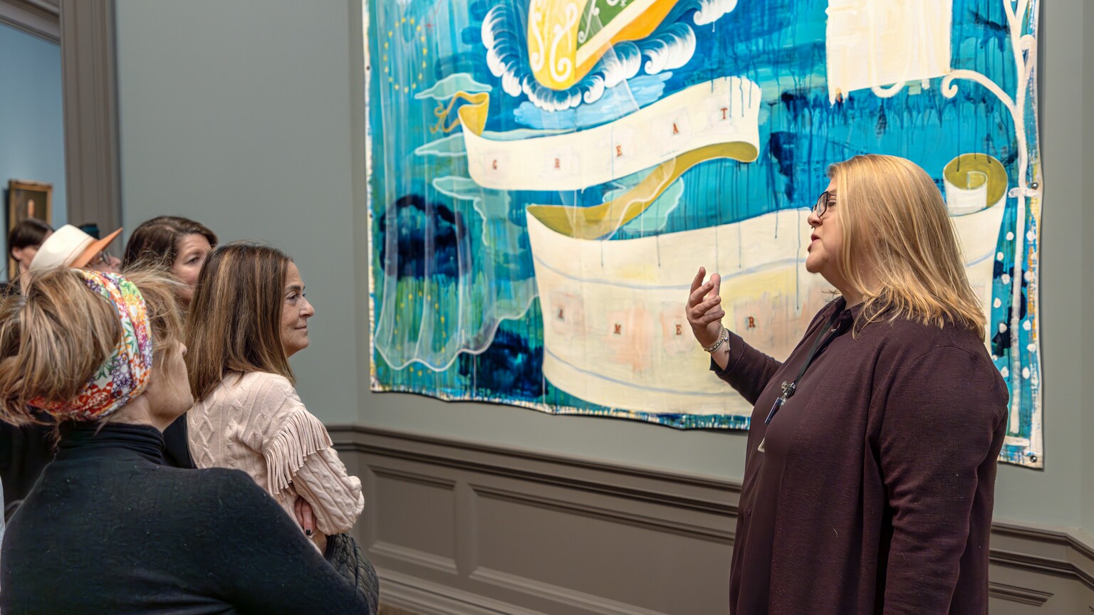Visitors look at a painting in the National Gallery of Art.