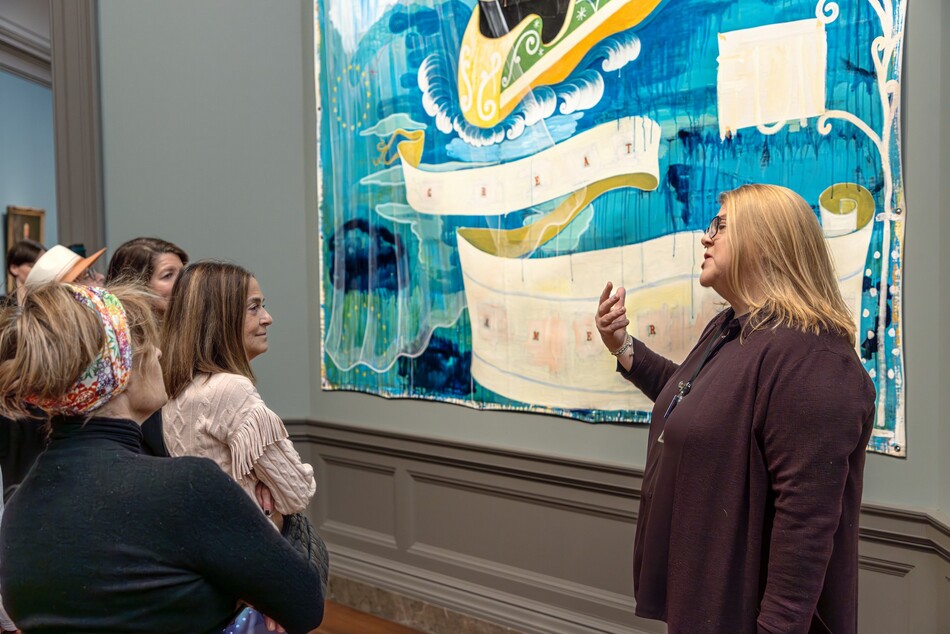 Visitors look at a painting in the National Gallery of Art.