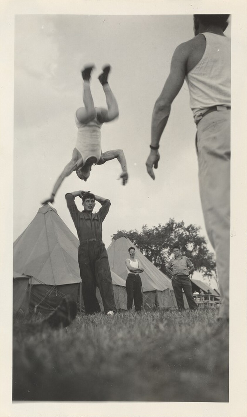 Untitled (Man flipping in air at camp)