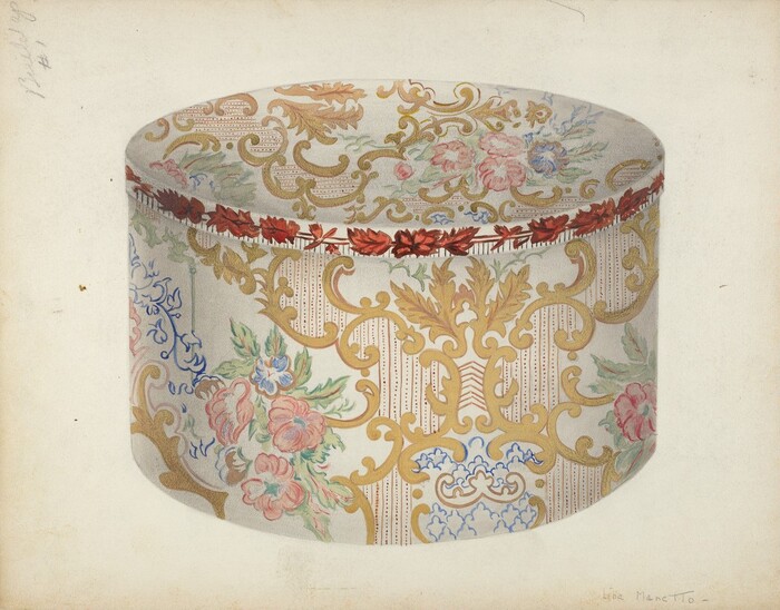 The image displays a large cylindrical box with an ornate floral and scroll pattern. The pattern includes vivid colors like gold, pink, red, blue, and green on a light background. A border of red flowers encircles the top edge of the box. The box is centered in the image, facing the viewer, and shown from a slightly elevated perspective to reveal both the top surface and the decorative side.