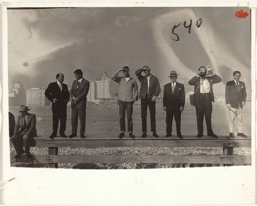 Men standing on fence, Greek parade--Long Beach, California
