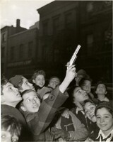 Boy Shooting "Zip" Gun in Air near Manhattan Police Headquarters, Mulberry and Mott Streets (Section Called "Little Italy"), New York City, Weegee, 1948