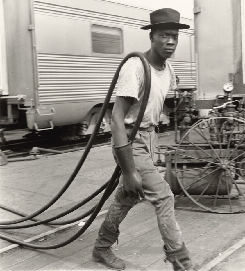 Railroad Passenger Car Maintenance Man. Air Hoses Were Used to Clean the Cars, Chicago, Illinois