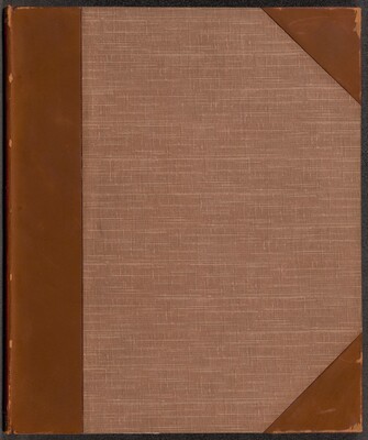This is a photograph of a book cover. The cover features a textured fabric material in a neutral brownish tone, with reinforced corners and spine made of a smooth, slightly darker brown material resembling leather. The stitching pattern on the fabric gives it a subtle crosshatch design. The book cover does not contain any visible text, illustrations, or embellishments.