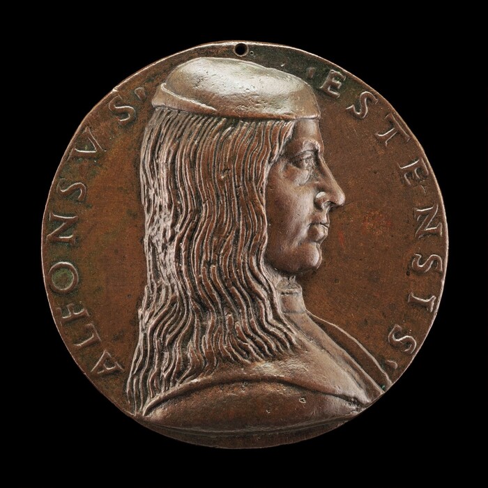 This image shows a profile view of a person on a round medallion. The focus is on a bust showing the person's head and part of their shoulders. The person is in a right-facing profile position with distinct facial features including a strong nose and chin. They have long, wavy hair reaching the neckline and are wearing a close-fitting cap. The clothing is simple and fitted, following the contours of the shoulders. Engraved letters encircle the outer edge of the medallion in a semicircular form. The background is the brownish color of the metal, possibly bronze, with no additional detail.