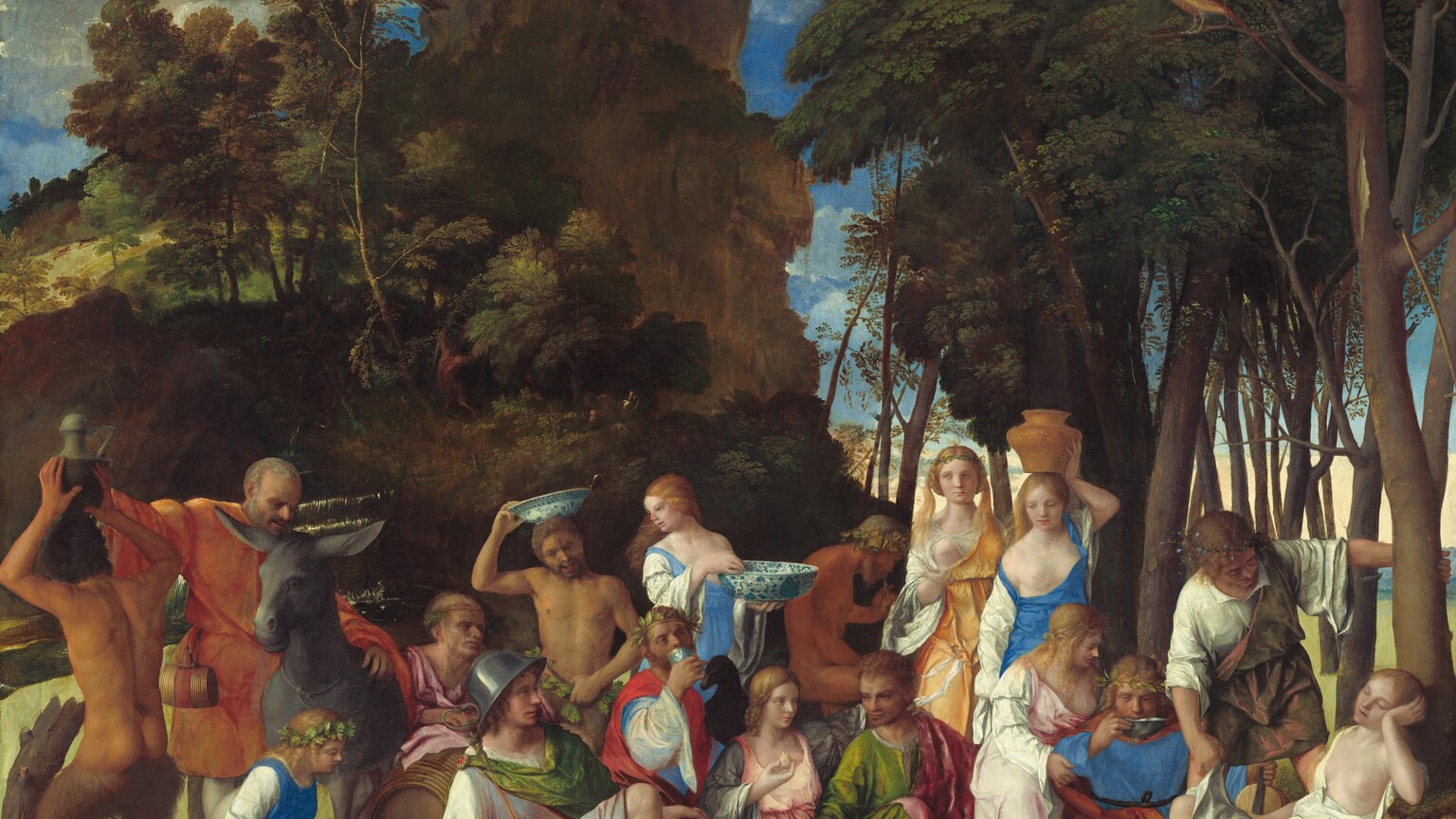 Six women, eight men, two satyrs, and one child gather in pairs and trios in a loose row that spans the width of this nearly square painting. They are set within a landscape with craggy rocks, cliffs, and trees. Most of the people face us, and the men, women, and child have pale skin. The two satyrs have men’s torsos and furry goat’s legs, and they have darker, olive complexions. Most of the men wear voluminous, knee-length togas wrapped in short robes in shades of white, topaz blue, grass green, coral orange, or rose pink. Most of the women wear long, dress-like garments in tones of shell pink, apricot orange, or lapis blue over white sleeves. For all but one woman, their garments have fallen off one shoulder to reveal a round, firm breast. Several objects are strewn on the rocky, dirt ground in front of the group, including a wide, wooden bucket with a piece of paper affixed to its front to our right, a glass goblet, a pitchfork, a large blue and white ceramic dish filled with grapes and small yellow fruits, and an overturned cup near the center. Cliff-like, craggy rocks rise steeply behind the group to our left, filling much of the sky opposite a tall grove of leafy, dark green trees to our right. A few puffy white clouds float across the vivid blue sky. The slip of paper on the barrel has been inscribed, “joannes bellinus venetus p MDXIIII.”