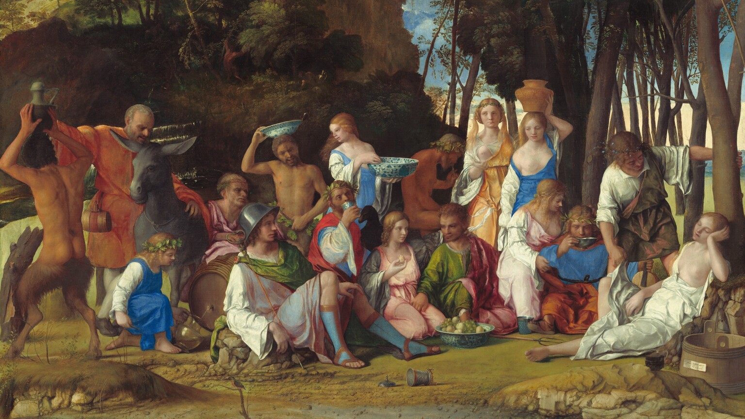 Six women, eight men, two satyrs, and one child gather in pairs and trios in a loose row that spans the width of this nearly square painting. They are set within a landscape with craggy rocks, cliffs, and trees. Most of the people face us, and the men, women, and child have pale skin. The two satyrs have men’s torsos and furry goat’s legs, and they have darker, olive complexions. Most of the men wear voluminous, knee-length togas wrapped in short robes in shades of white, topaz blue, grass green, coral orange, or rose pink. Most of the women wear long, dress-like garments in tones of shell pink, apricot orange, or lapis blue over white sleeves. For all but one woman, their garments have fallen off one shoulder to reveal a round, firm breast. Several objects are strewn on the rocky, dirt ground in front of the group, including a wide, wooden bucket with a piece of paper affixed to its front to our right, a glass goblet, a pitchfork, a large blue and white ceramic dish filled with grapes and small yellow fruits, and an overturned cup near the center. Cliff-like, craggy rocks rise steeply behind the group to our left, filling much of the sky opposite a tall grove of leafy, dark green trees to our right. A few puffy white clouds float across the vivid blue sky. The slip of paper on the barrel has been inscribed, “joannes bellinus venetus p MDXIIII.”