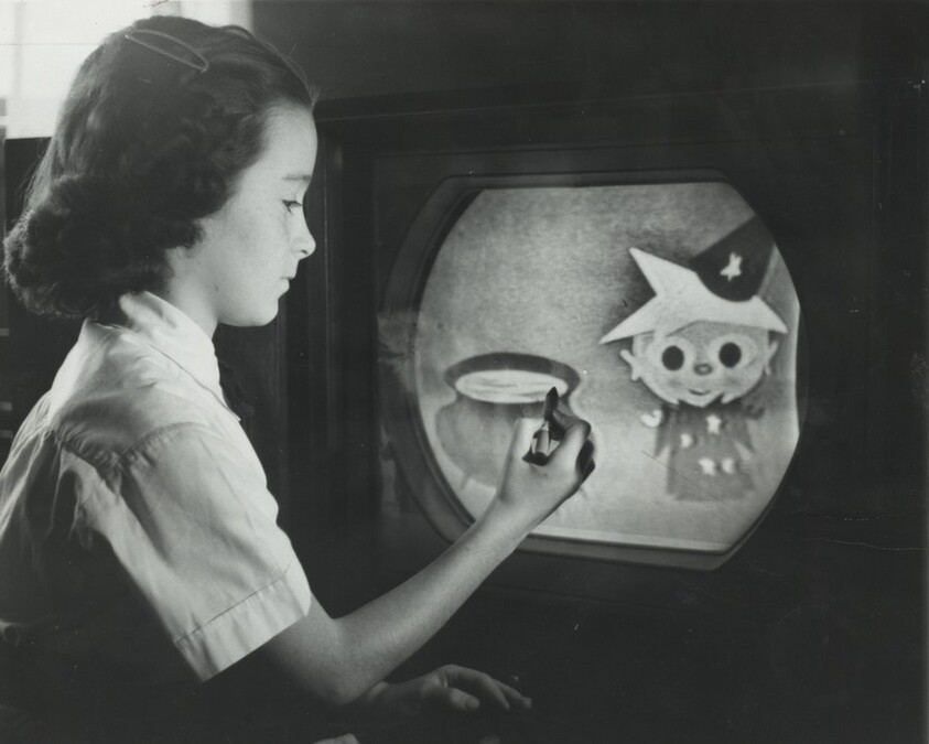 Title from caption on object: "On the Thin Plastic with Which She Has Covered the Screen of Her Home Television…”