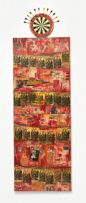Two vertically oriented, rectangular canvases are stacked over each other, and a dart board is affixed to the uppermost edge. The canvases are collaged with newspaper articles, headlines, black-and-white pamphlets, cartoons, comic books, illustrations of animals like chipmunks and buffalo, and a triangular pennant celebrating the “Washington Redskins” as “Super Bowl XXVI CHAMPIONS.” Streaks and drips of red paint create horizontal bands across the panels, separated by bands streaked in yellow. Text is visible throughout, including the title of the pamphlet, which repeats across the composition: “Community Service and Interest Courses/Workshop.” Headlines include “The Heist,” “For People Who Inherited Brains Instead of Wealth,” “Defying the Stereotypes,” and “Destroy The Myth.” The comic is titled “Son of Tomahawk,” and fliers are titled “Help Locate Handicapped Indian Children” and “2nd Annual Flathead Reservation Culture Fair.” One piece of blue fabric with white polka dots is along the bottom edge of the top panel and a piece of red fabric with white dots is along the bottom edge of the lower panel. The outer band of the dart board is smeared with red, and darts with red, blue, yellow, or green feathers line the upper perimeter of the board.