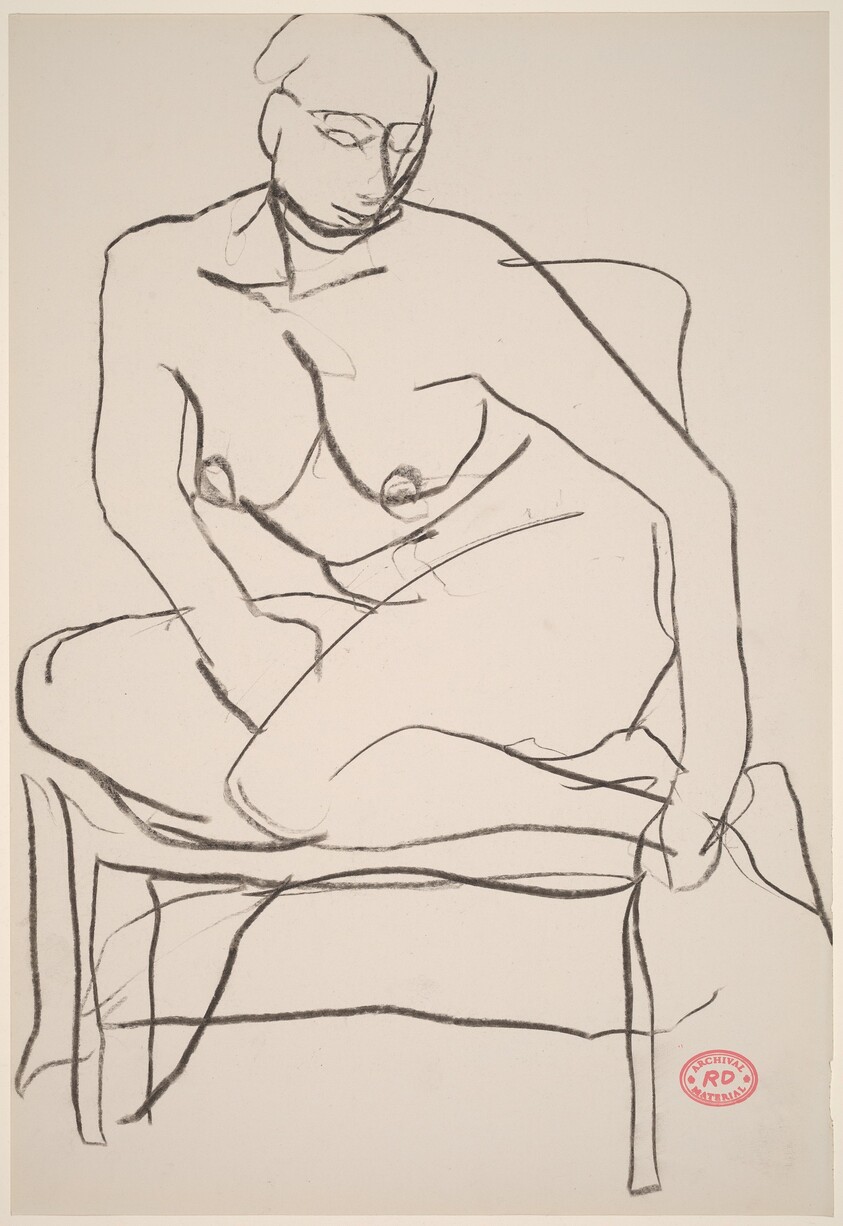 Untitled [female nude with legs drawn into chair]