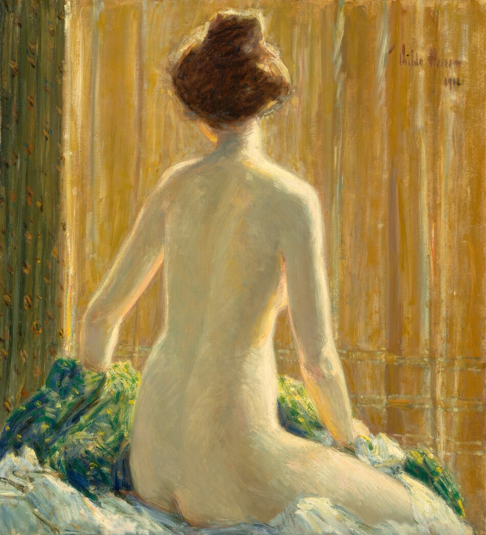 A nude, pale-skinned woman sits facing away from us on a surface with bunches of blue and green-toned fabrics in this vertical painting. The woman’s right knee and torso angle away from us to the right, but she turns her head a bit to our left so we see the underside of her chin. Her brown hair is pulled up loosely into a high bun. Her right hand rests on fabric bunched on that leg, and her other hand disappears on the far side of lemon-lime green and celestial-blue pile of cloth near the lower left corner of the painting. The background is mostly golden yellow, perhaps a curtain, with some vertical pleats in moss green along the left side. The woman is lit from our right so the edges of her right arm, breast, torso, leg, and neck glow. The scene is loosely painted but has an overall soft, blended look. The artist signed and dated the painting in the top right corner, “Childe Hassam 1912.”