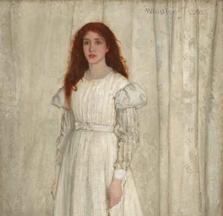 A young woman with pale, peachy skin, wearing a long, flowing white dress, stands in front of a white curtain in this vertical portrait painting. Her auburn-red hair cascades down over and behind her shoulders. She looks to our left with green eyes, and her pink, full lips are closed. Her dress has puffed shoulders above a white-on-white striped pattern on the long sleeves. She stands on an animal pelt; it is not clear whether it is a wolf or a bear. The pelt spans the width of the painting and overlaps a blue patterned carpet. The animal’s mouth gapes to show sharp teeth. Its glassy eyes are wide open, and it seems to look at us. The edges of the animal skin are red. The woman holds a white lily by her side in her left hand, while yellow and purple flowers lie scattered on the pelt.