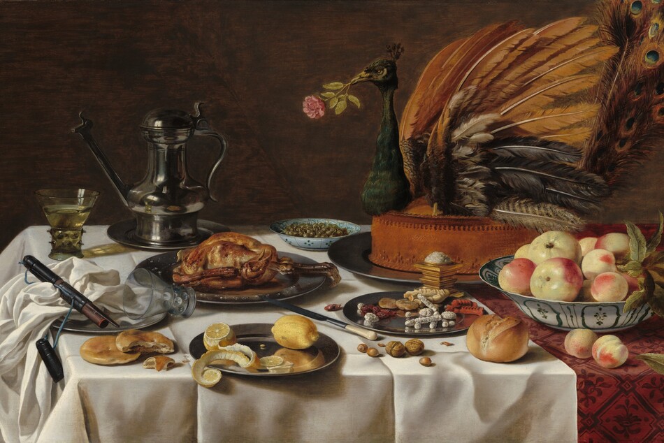 On a tabletop spread with an ivory-white cloth, plates, and white porcelain bowls containing sweets, fruit, olives, and a cooked fowl are arranged around the largest platter, which holds the head, wings, and tail of a peacock stuck into a tall, baked pie, in this horizontal still life painting. The front, left corner of the table is near the lower left corner of the painting, so the tabletop extends off the right side of the composition. The white tablecloth lies over a second cloth underneath, which is only visible along the right edge. The cloth underneath has a leafy, geometric pattern in burgundy red against a lighter, rose-red background. The peacock pie is set near the back of the table, to our right, so it fills the upper right quadrant of the composition. The bird holds a pink rose in its beak. In front of it, near the lower right corner of the painting, a white porcelain bowl painted with teal-green floral and geometric designs holds about ten pieces of pale yellow and blush-red fruit. A pewter plate next to it, to our left, holds dried fruit and baked, stick-like sweets, some covered with white sugar. A pile of salt sits atop a gold, square vessel between the sweets and the peacock pie. Another blue-patterned, white porcelain bowl filled with green olives sits near the back of the table next to a lidded, pewter pitcher with a long spout. Other pewter plates hold a baked fowl, like a small chicken, and, closest to us, a partially cut lemon with its peel curling off the plate. Nuts, more fruit, an ivory-handled knife, bread rolls, and flat biscuits sit on the white cloth among the plates. One glass with a wide stem covered in nubs and a flaring bowl sits near the back, left corner of the table, filled with a pale yellow liquid. An empty glass lies with the upper rim on another pewter plate, to our left. Also on the plate is a bunched up white napkin and a leather case for the knife. The background behind the still life is brown.