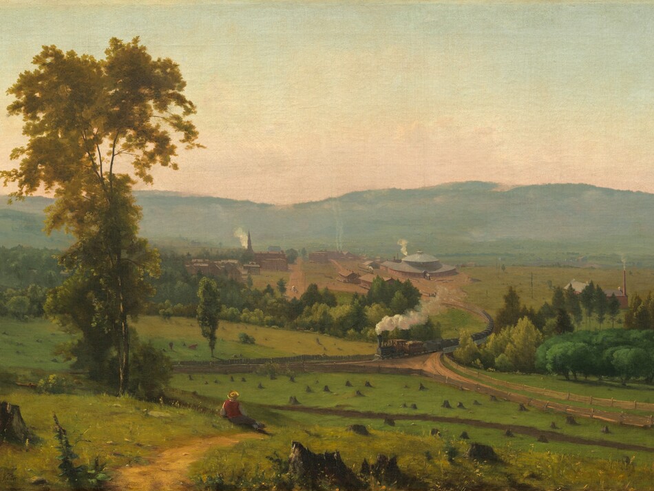 We look across and down into a valley with a person sitting near a tall tree and a train puffing smoke beyond, all enclosed by a band of mountains in the distance in this horizontal landscape painting. Closest to us, several broken, jagged tree stumps are spaced across the painting’s width. A little distance away and to our left, the person wears a yellow, broad-brimmed hat, red vest, and gray pants. He reclines propped on his left elbow near a walking path beside a tall, slender tree with golden leaves. The green meadow stretching in front of him is dotted with tree stumps cut close to the ground. Beyond the meadow, puffs of white smoke trail behind a long steam locomotive that crosses a bridge spanning a tree-filled ravine, headed to our left. The ravine creates a diagonal line across the canvas, moving subtly away from us to our left. The train has climbed out of the valley, away from a cluster of brick-red buildings. The most prominent structure is a train roundhouse, a large building with a high, domed roof to the right of the tracks. Smoke rises from chimneys on long, warehouse-like buildings, and a steeple and smaller structures suggest a church and homes to our left. Hazy in the distance, a row of mountains lines the horizon, which comes about halfway up the composition. The sky above deepens from pale, shell pink over the mountains to watery, pale blue above. The artist signed the work in tiny letters in the lower left corner: “G. Inness.”