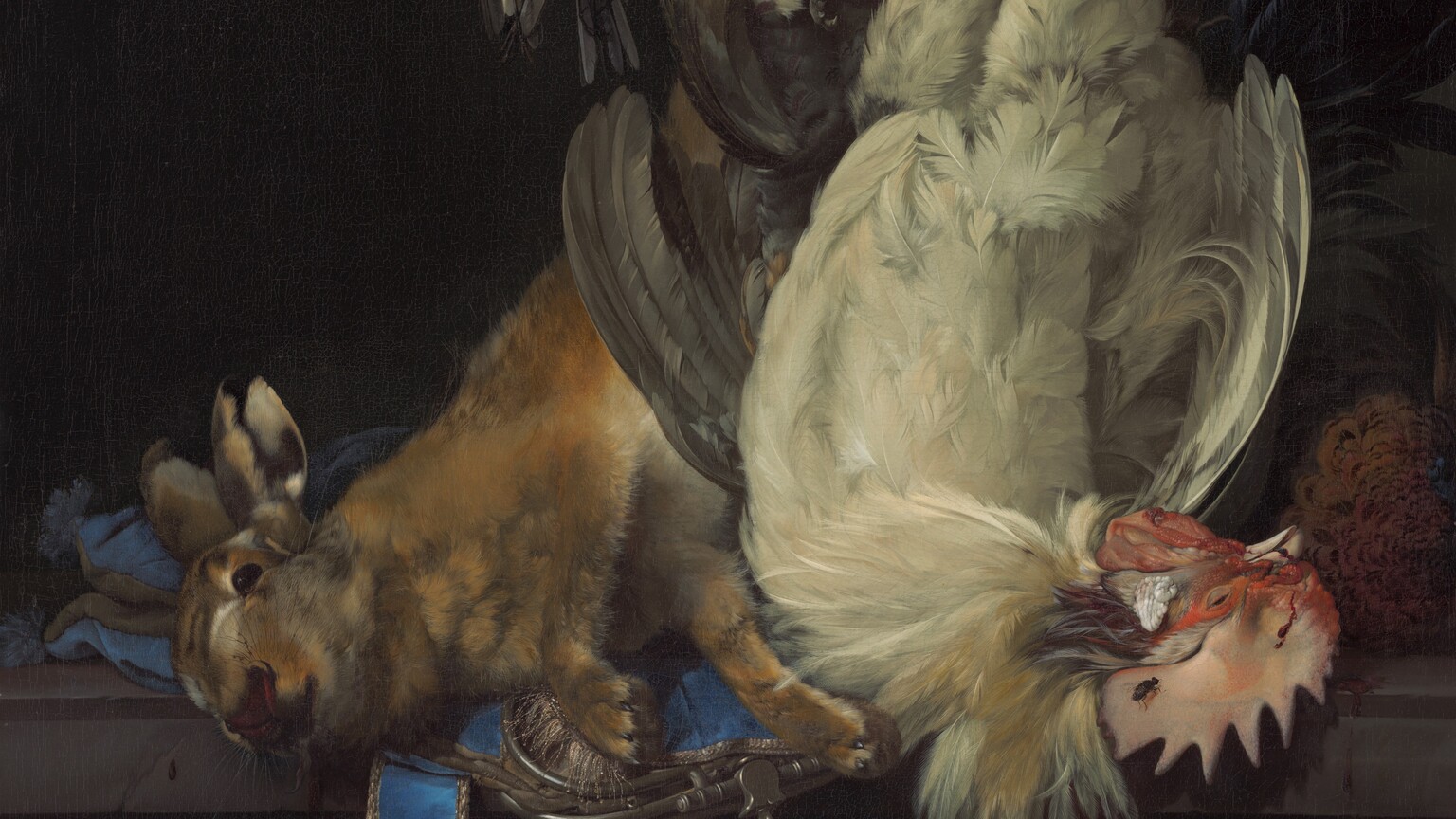 Two roosters, a rabbit, and three small birds hang from the top of this vertical still life painting, so the heads of one white rooster and the rabbit come to rest on a dark stone ledge, about a third of the way up the composition. To our left, the tawny-brown rabbit’s nose faces us as the head rests on an azure-blue purse with silver lining. A pair of scissors is tucked behind the strap, which falls down over the ledge. To our right, the head of the rooster curves away with its red coxcomb coming toward us. A black fly rests on the rooster’s comb. The black tail feathers of another rooster arc out behind it, near the upper right corner of the painting. In front of the rabbit's bound, hind legs is a small bird with puffed, silvery-gray feathers, and one black leg tied up with a dark cord. To our left are two more small birds, one with gray, cream, and tan feathers, the other with cream, golden orange, and lapis blue. These two are secured with their beaks pointing upward. Two white and scarlet-red caps, falcon’s hoods, are strung up by white ribbon near the pair of birds. Below the ledge is a carved scene with nude or nearly nude people, but this area is mostly in shadow. Behind the animals is a dark, nearly black wall.