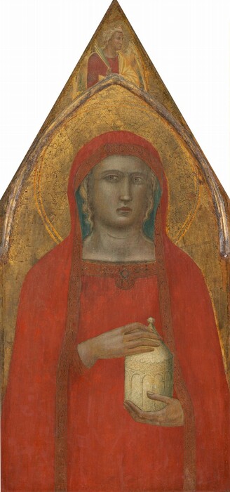 Shown from the hips up, a woman holds an ivory-white, cylindrical jar against a gold background on a panel shaped to come to a sharp point at the top of this vertical painting. The pale skin of the woman is faintly tinted with green. Her body faces us, and she looks at or past us with wide, hooded, light brown eyes under faint brows. She has a long, straight nose, and her pink bow-shaped lips are closed. The woman wears a tomato-red mantle that covers her head and drapes down past her shoulders and over her matching dress. Locks of blond hair show under the mantle on the sides of her face. Bands of geometric designs made with black lines decorate the edges of her mantle and the neckline of her dress. The woman holds her left hand under the jar and her right hand holds onto its peaked lid. A disk-like halo with a floral pattern is incised into the gold background behind the woman. Above the woman, narrow molding affixed to the panel creates a rounded but pointed arch set under the sharp point at the top of the panel. Between the arch and the triangular tip, an angel with harvest-gold wings and blond hair is shown from the chest up. The angel’s body faces us but the head is in profile to our right. A narrow palm frond is held by one shoulder, and a butter-yellow cloth drapes over a cardinal-red gown. The surface of the painting is cracked and chipped, especially in the gold areas.