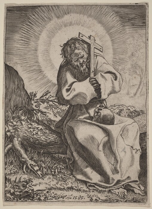 The image shows a man seated against a cross, holding it to his chest. He has long hair, a beard, and a contemplative expression. He wears a robe and rests his bare feet on the ground, with a skull in his lap. The background includes trees and a fallen log, with a glowing effect around the man's head.