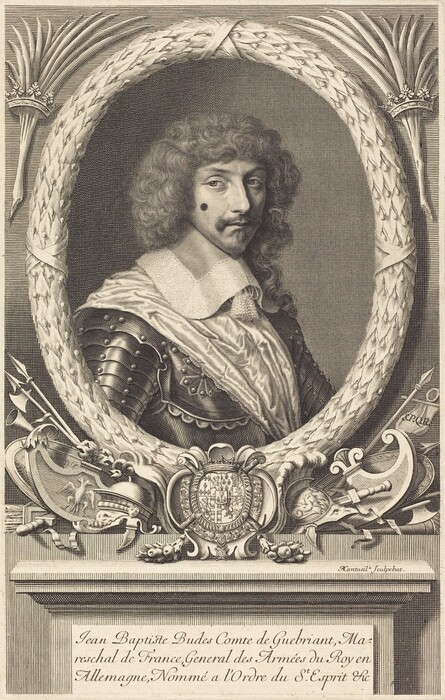 The image is a detailed portrait engraving showing the upper body of a man within an ornate oval frame. The man is positioned at a slight angle, gazing towards the viewer. He has a prominent facial structure, with long, curly hair that reaches to his shoulders, a mustache, a small pointed beard, and a beauty mark on his cheek. He is dressed in luxurious clothing typical of a historical military figure, featuring a ruffled collar and a suit of armor with intricate detailing. The man appears to be depicted with decorative armor and a sash over his shoulder. Around him, within the oval frame, are decorative elements including palm fronds and a crest with heraldic symbols. The background consists of diagonally lined shading, creating contrast with the intricately illustrated frame, which includes various elements such as a helmet, a shield adorned with the crest, and a pair of crossed halberds. The name and titles of the person are inscribed underneath the portrait.