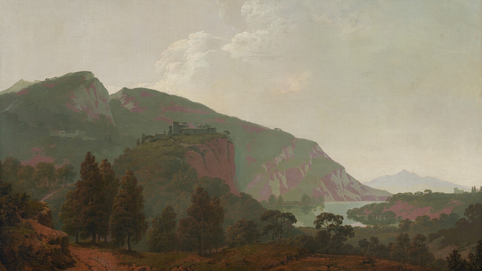 Mountains painted in tones of sage and mint green and mauve purple are backlit against a hazy sky in this expansive, nearly square landscape painting. In the bottom quarter of the composition, the dirt-packed land is partially covered with patches of scrubby grass. A person, tiny in the landscape, sits on a rock to the left of the bottom center of the painting. That person has pale skin and wears a wide-brimmed, dark hat, a slate-blue jacket, muted red pants, and shin-high boots. He rests his head in one hand, that elbow propped on his bent knee. He braces a stick, perhaps a walking stick, against the other shoulder, and a canteen hangs by one hip. A path starting in the lower left corner of the painting winds back into the deep distance. A complex of pale-colored buildings sits on a rocky cliff face near the center of the composition, and another complex is tucked on a distant mountain to the left. The mountains span the left two-thirds of the painting and taper down to meet a crescent-shaped body of water to the right. Another building in the deep distance near the right edge of the canvas is outlined against a smoky, pale blue ridge. White clouds pile in the hazy sky in the top half of the painting. The artist signed and dated the painting in the lower left corner, “I Wright Pinx 1790.”
