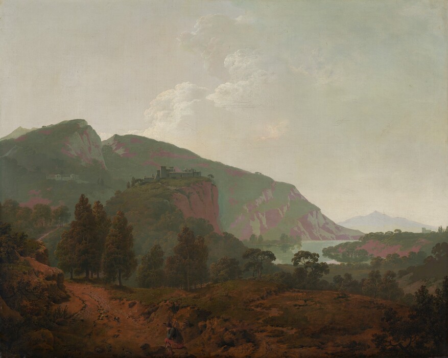 Mountains painted in tones of sage and mint green and mauve purple are backlit against a hazy sky in this expansive, nearly square landscape painting. In the bottom quarter of the composition, the dirt-packed land is partially covered with patches of scrubby grass. A person, tiny in the landscape, sits on a rock to the left of the bottom center of the painting. That person has pale skin and wears a wide-brimmed, dark hat, a slate-blue jacket, muted red pants, and shin-high boots. He rests his head in one hand, that elbow propped on his bent knee. He braces a stick, perhaps a walking stick, against the other shoulder, and a canteen hangs by one hip. A path starting in the lower left corner of the painting winds back into the deep distance. A complex of pale-colored buildings sits on a rocky cliff face near the center of the composition, and another complex is tucked on a distant mountain to the left. The mountains span the left two-thirds of the painting and taper down to meet a crescent-shaped body of water to the right. Another building in the deep distance near the right edge of the canvas is outlined against a smoky, pale blue ridge. White clouds pile in the hazy sky in the top half of the painting. The artist signed and dated the painting in the lower left corner, “I Wright Pinx 1790.”