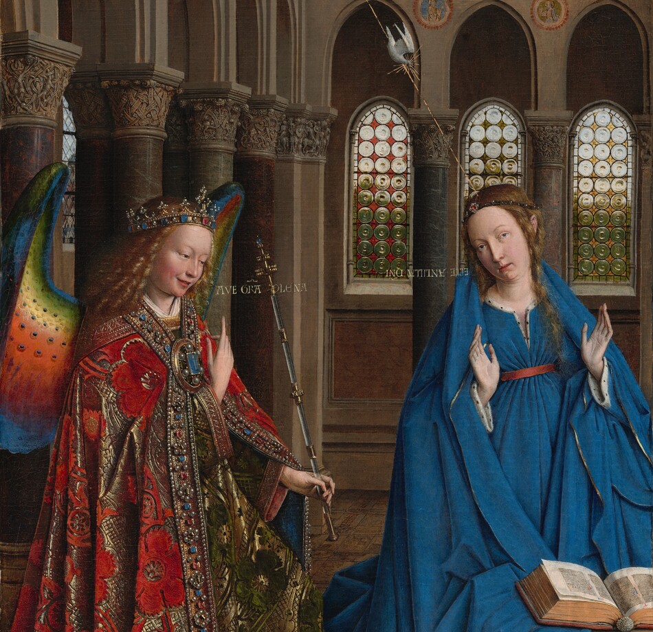 A woman and winged angel, both with pale, peach skin, are situated in a church interior in this tall, narrow painting. To our left, the angel has long, blond, curly hair, smooth skin, and is smiling. The wings are outlined in royal blue, and they blend from blue to green to yellow to crimson. The angel holds one hand, closer to us, up at chest height with the index finger subtly pointing upward. Holding a long scepter in the other hand, the angel angles their body toward the woman to our right. The angel wears a gold jewel and pearl-encrusted crown and a jeweled long, voluminous robe in scarlet-red and shimmering gold brocade. The neck and along the opening down the front are lined with pearls and jewels. The angel looks toward the woman, who wears a royal-blue dress tied with a red belt at the high waist. Her long brown hair is tied back but one tendril falls over her left shoulder, to our right. She kneels facing us with her raised hands facing outward. Her head is tipped a bit to our left, and she looks up and into the distance to our right with lips slightly parted. She kneels behind a book lying open on a low table. A vase of white lilies and a red cushion lies on the floor in front of the table, close to us. The floor is decorated with people and scenes outlined in black and set into square panels, as if inlaid with wood. The church behind and above the people has a row of tall, narrow arches with bull’s-eye glass windows. A walkway lined with columns runs above the arches, and sunlight comes in through arched windows under the flat wood ceiling. A white dove flies toward the woman on gold lines from a window at the upper left of the painting. Latin words painted in gold capital letters are exchanged between the people. The angel says, “AVE GRA PLENA.” The letters of the woman’s response are painted upside down and backward: “ECCE ANCILLA DNI.”