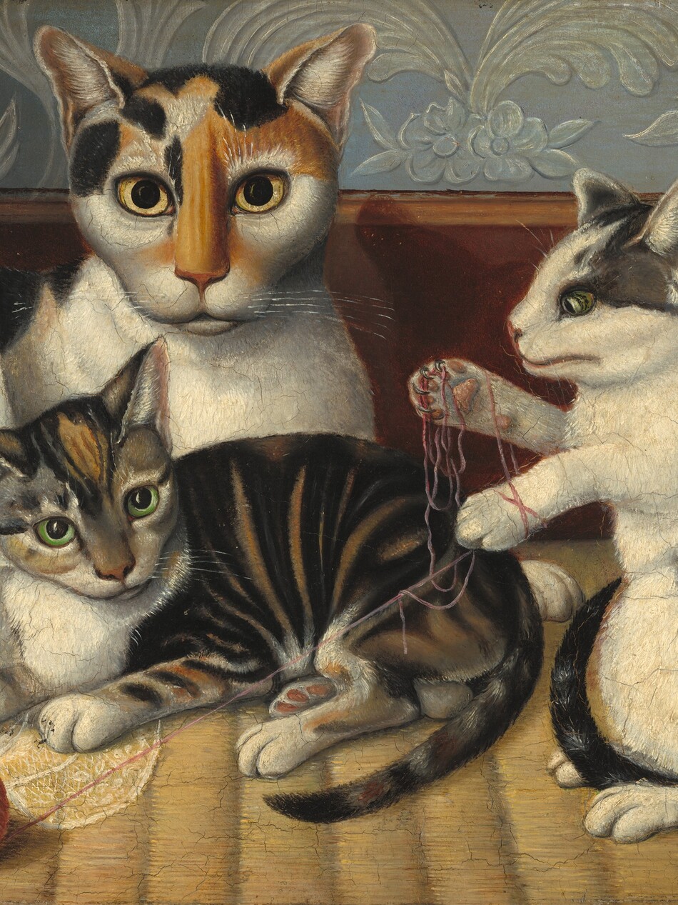 A short-haired calico cat and two kittens lie down or play with a ball of yarn in this horizontal painting. To our left, the largest cat has markings in honey brown and black over its face and along its spine, and the rest of its fur is white. Most of its body disappears behind a lace-trimmed cloth hanging along the left edge of the painting but it lies down so its chest faces us and it looks at us with piercing yellow eyes. One kitten lies in front of the larger cat so all four legs and its tail face us. It has caramel-brown, gray, and black stripes with white patches on its nose, chest, and paws. It looks off to our right with lime-green eyes. To our right, the other kitten rests up on its hind paws so its front paws are free to tangle the end of the carnation-pink yarn, which has rolled off a tidily wound ball to our left, in front of the other kitten. This kitten faces our left in profile and has white fur with flint-gray and black splotches along its spine, tail, and around its ears and eyes. The textured rug beneath the cats is straw yellow. A chestnut-brown baseboard spans the painting behind the cats, and the wall above is slate blue with stylized floral patterns in translucent white. The artist’s precise brushstrokes are especially noticeable in the cats’ fur and their shining whiskers.