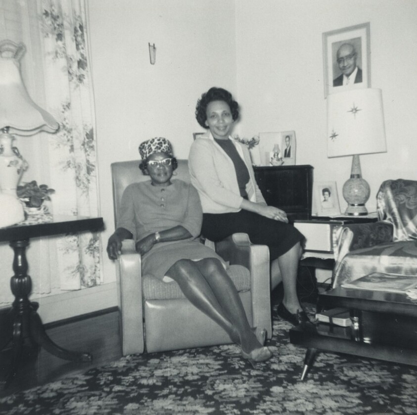 Untitled (Two women sitting in living room)
