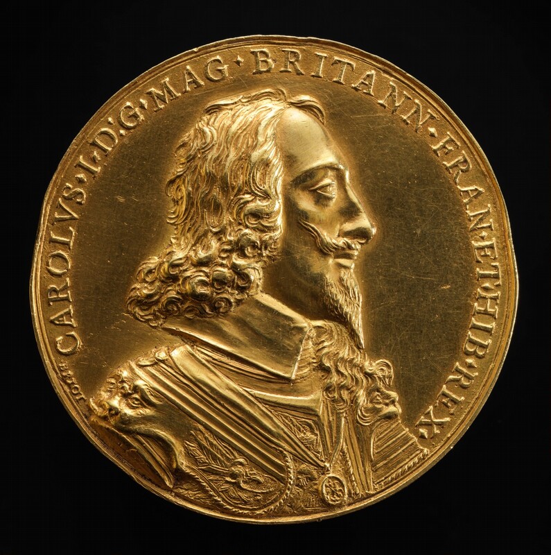 A man faces to our right in profile in low relief on this gold, round medallion. The man has heavy-lidded eyes under low brows, a slightly bumped nose, and his lips are closed. He has chin-length, curly hair, a tapered, pointed beard, and a thin mustache that points up. A high, flat collar hugs his jawline under armor decorated with stylized faces on the shoulders. A chain and pendant lies over his chest. A Latin inscription lines the perimeter: “CAROLVS I D:G MAG BRITANN FRAN ET HIB REX.” In smaller letters to the left at the start of the inscription is the artist’s name, “Briot.”