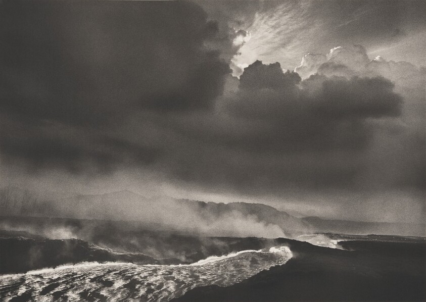 Fiery lava flows out of the crater through an underground break. Volcanic eruption of Mount Nyamulagira in May 2004. Democratic Republic of Congo.