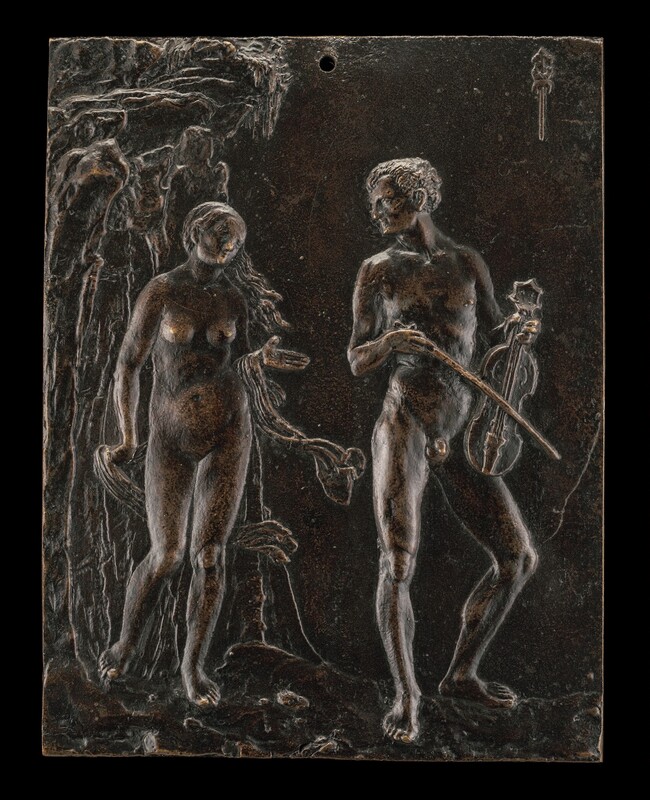 A man and woman, both nude, stand on a rocky ground in this vertical, rectangular bronze plaque. The woman is to our left. She stands with most of her weight on her left foot, to our right and closer to the man. She holds fluttering drapery down by her side with her right hand, to our left, and lifts the other, palm up, toward the man. Her head tips to our right and a breeze lifts her long hair as she looks at the man. She stands in front of a rocky cliff face that fills the left third of the composition. To our right, the man stands with his body angled slightly in that direction. He is muscular and has short hair. He holds a violin-like instrument by the neck and facing out from his body, down in front of one hip. He looks over one shoulder at the woman. A hole pierces the top center of the plaque, and a symbol cast in the top right corner shows two back-to-back crescent-shaped fish pierced by a dagger.