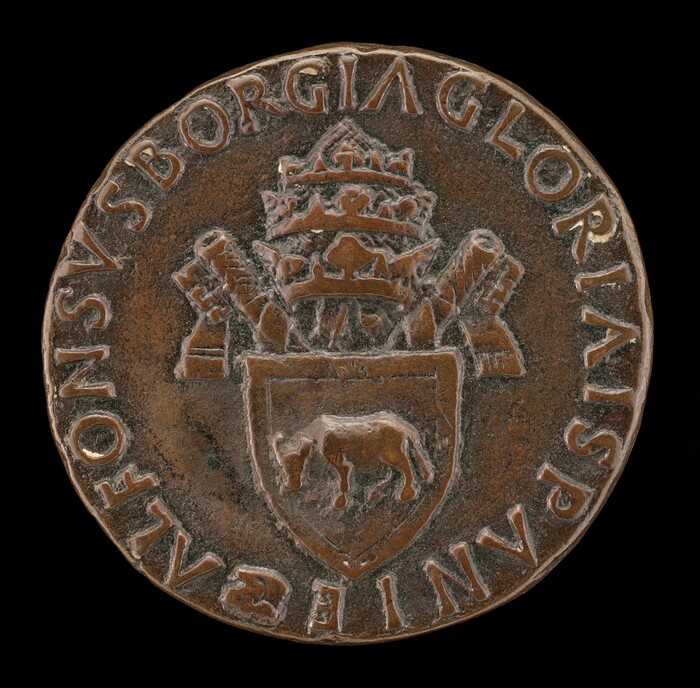 The sculpture is a circular medallion with a central design of a crowned emblem with two crossed keys. At the center is a shield containing the depiction of an animal. Surrounding the central imagery is an inscription in capital letters forming a circular border. The sculpture appears to be crafted from a brownish metal, likely bronze. The surface features detailed engravings creating intricate textures. The styling and iconography connect strongly with traditional heraldic and ecclesiastical motifs.