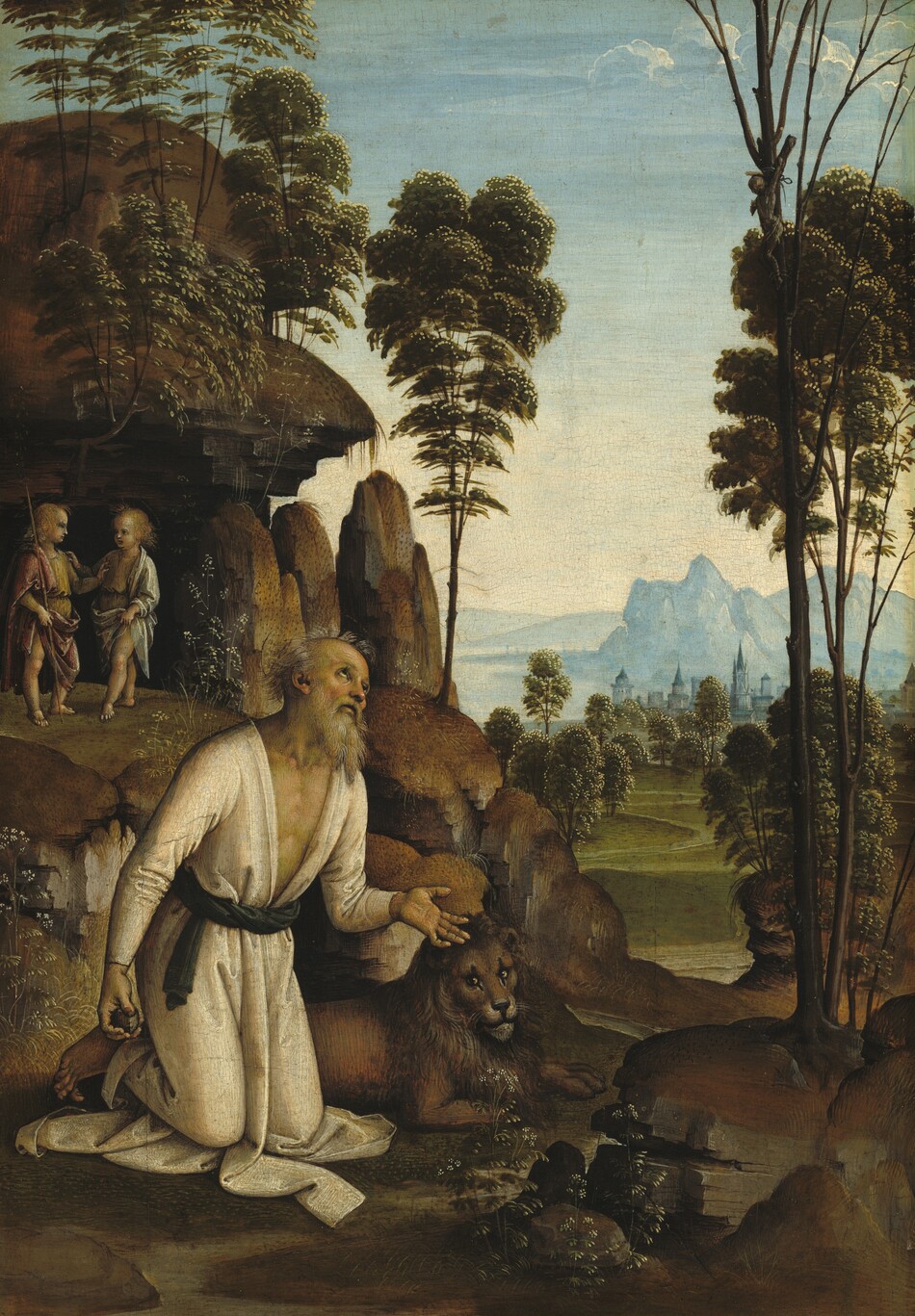 A balding man with a long gray beard kneels on the edge of a stream, next to a lion, while two young boys stand in a rocky alcove in the landscape background of this vertical painting. The man and boys all have pale skin. The man, Saint Jerome, kneels with his body angled to our right as he looks up with dark eyes. His wispy hair and full beard are streaked with silver and honey gold. The faint gold line of his halo nearly disappears in the background. His nose and high cheekbones are flushed, his mouth slightly open. His long-sleeved ivory-white robe puddles under his knees. The robe is open to create a deep V that reaches to the forest-green sash tied around his waist. He holds a rock in his right hand, to our left, by his side, and holds the palm of his other hand up. The lion lies with its head lifted, looking at or toward us, on the far side of Saint Jerome. The silvery water of the river curves around gray boulders in the lower right corner of the painting and winds into the distance. The riverbank is covered in olive-green grass with some small white flowers. Behind Saint Jerome, the land rises to a cave-like outcropping. The two boys stand facing each other in the shadowy entrance. Both have blond hair, faint gold halos, and are barefoot. They wear gold-colored tunics, and each touches the chest of the other. The boy to our left wears a wine-red cloak and holds a long staff topped with a small cross. The other boy wears a white cloak. Plants and trees grow over the rocks above. The river curves through a flat field lined with trees, leading back to a town with towers and spires painted in tones of sky blue. Pale blue mountains rise along the water’s edge beyond the town. The sky deepens from light yellow along the horizon to icy blue above, where a few puffy clouds float along the top edge of the composition.