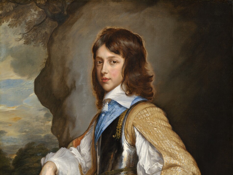 Shown from the hips up, a boy with pale, peachy skin and copper-brown hair stands in front of a rocky outcropping with a narrow view into a distant landscape to our left in this vertical portrait painting. His body faces our left almost in profile, and he turns his face to look at us with dark brown eyes under faint brows. He has a long, straight nose, a pointed chin, flushed cheeks, and his full, rose-pink lips are slightly parted. His dark hair falls in waves to the wide, flat, white collar at his neck. He wears a golden yellow doublet brocaded with shimmering threads, possibly silver and gold. The sleeves split along the inner arm to reveal a white shirt with voluminous, puffy sleeves that end with wide, transparent cuffs like floppy saucers around each wrist. Over the jacket, he wears a gleaming, pewter-colored breastplate with a topaz-blue sash crossing his chest. His peanut-brown pants are also sewn or woven with metallic thread in stripes down the side of the leg. The boy rests his right hand, farther from us, on a staff or walking stick propped in front of him. His other hand rests around the gold hilt of a rapier, a thin sword at his left hip, closer to us. Behind the boy, the view is almost entirely taken up with a slate-gray boulder, or it could be the entrance of a cave. A view onto the landscape along the left edge of the composition has a few treetops beneath pale yellow clouds against an ice-blue sky.