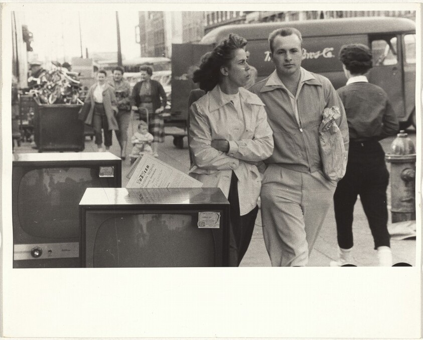 Couple walking past television sets--Chattanooga, Tennessee