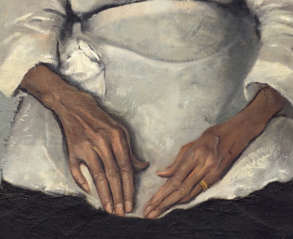 Shown from the knees up, a woman with brown, wrinkled skin, wearing a white blouse, apron, and black skirt is shown in front of a pale gray background in this vertical portrait painting. Straight-backed, she faces and looks at us with her hands resting in her lap. Her wavy, iron-gray hair is parted in the center and pulled back from her face. Her eyebrows are slightly raised, and her face is deeply lined down her cheeks and around her mouth. She wears a heart-shaped brooch with a red stone at its center at her neck and a gold band on her left ring finger. The light coming from our left casts a shadow against the wall to our right. The artist signed and dated the painting in the lower right corner: “A.J. MOTLEY. JR. 1922.”