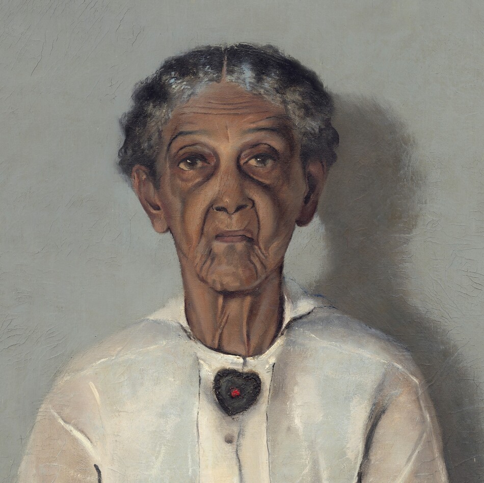 Shown from the knees up, a woman with brown, wrinkled skin, wearing a white blouse, apron, and black skirt is shown in front of a pale gray background in this vertical portrait painting. Straight-backed, she faces and looks at us with her hands resting in her lap. Her wavy, iron-gray hair is parted in the center and pulled back from her face. Her eyebrows are slightly raised, and her face is deeply lined down her cheeks and around her mouth. She wears a heart-shaped brooch with a red stone at its center at her neck and a gold band on her left ring finger. The light coming from our left casts a shadow against the wall to our right. The artist signed and dated the painting in the lower right corner: “A.J. MOTLEY. JR. 1922.”