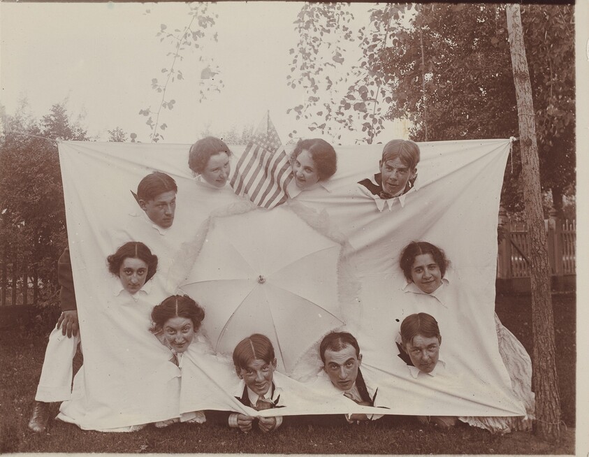 Untitled (Group sticking heads through a sheet)