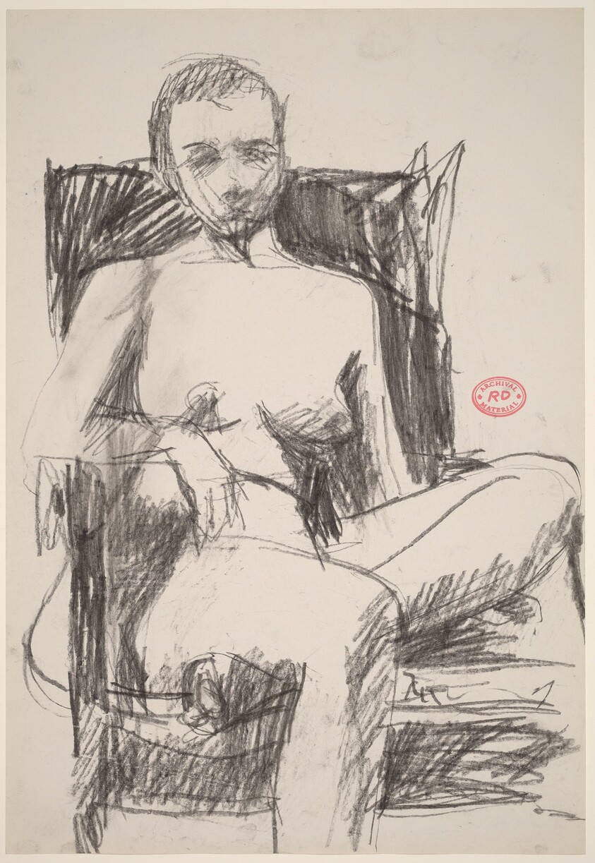 Untitled [female nude in a dark armchair]