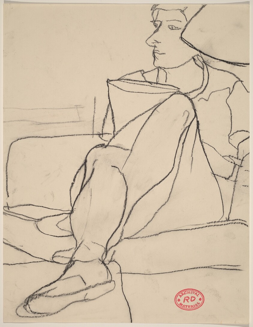 Untitled [woman seated on sofa with legs crossed]