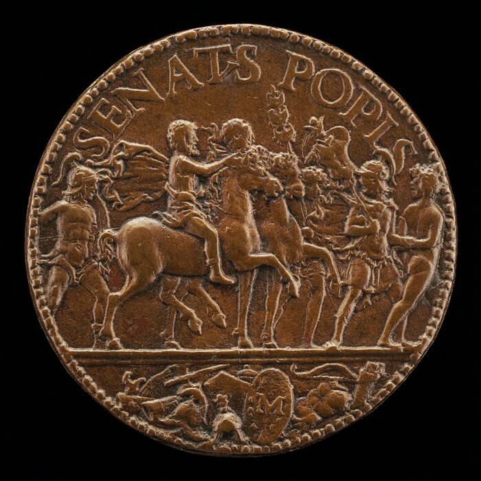 This is a photograph of an ancient coin. The coin features a relief design depicting a group of figures, including a central figure on horseback surrounded by others, some holding banners or weapons. Below this scene is a smaller frieze depicting additional figures and elements such as shields. The outer periphery of the coin is inscribed with the words "SENATS POPLIS." The craftsmanship indicates close attention to detail, common in ancient civilizations' numismatic art. The coin appears to be made from a copper alloy, giving it an aged appearance.