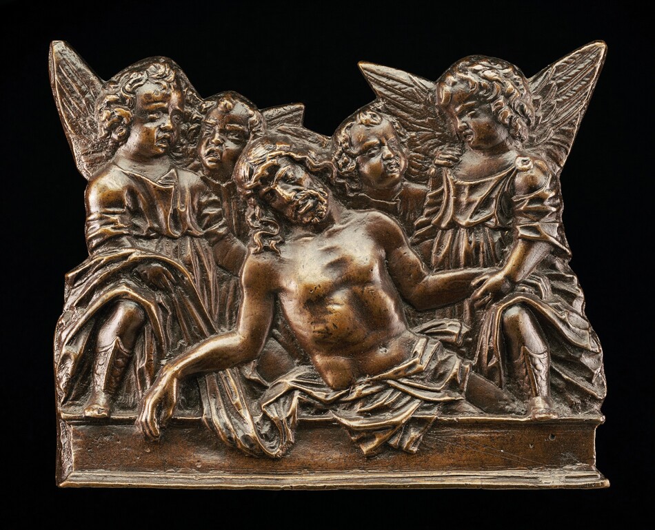 The sculpture features a group of figures centered around a reclining male figure with a serene expression. Four smaller figures, likely angels, with visible wings are positioned around the central figure in supportive or comforting gestures. The sculpture is made of a metallic material with a bronze-like color highlighting intricate details of the figures' clothing, hair, and wings. The piece has a relief-like quality with depth from the overlapping figures, creating a sense of dimensionality.