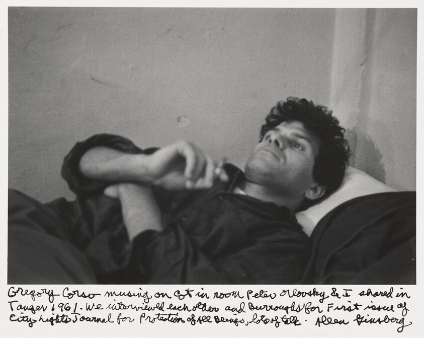 Gregory Corso musing on cot in room Peter Orlovsky & I shared in Tangier 1961 - we interviewed each other and Burroughs for first issue of City Lights Journal for Protection of All Beings, lots of talk.