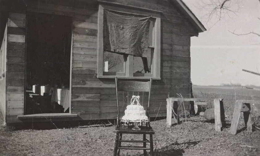 Untitled (Cake on chair in front of house)