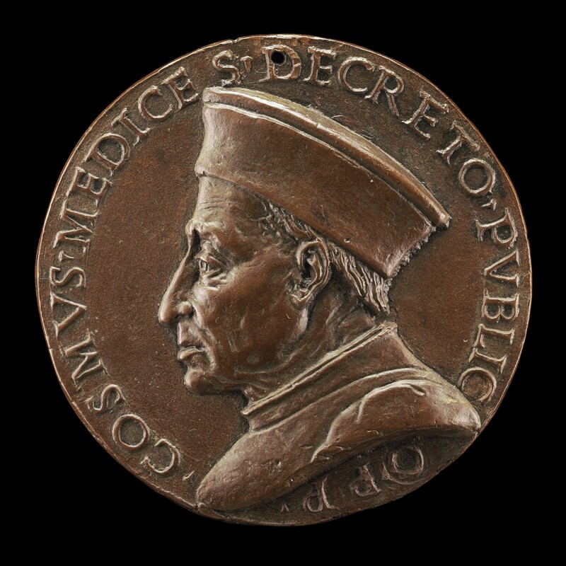 Cast in low relief, a cleanshaven man with a lined face and sagging jowls faces our left in profile on this round bronze medallion. His long nose points down at the end and wrinkles line his forehead. The corner of his mouth that we see is turned slightly down. His short hair is mostly covered by a brimless cap that flares slightly out away from the crown, and he wears a high-necked garment. An inscription around the perimeter of the medallion reads, “COSMVS MEDICE S DECRETO PVBLICO PP.”