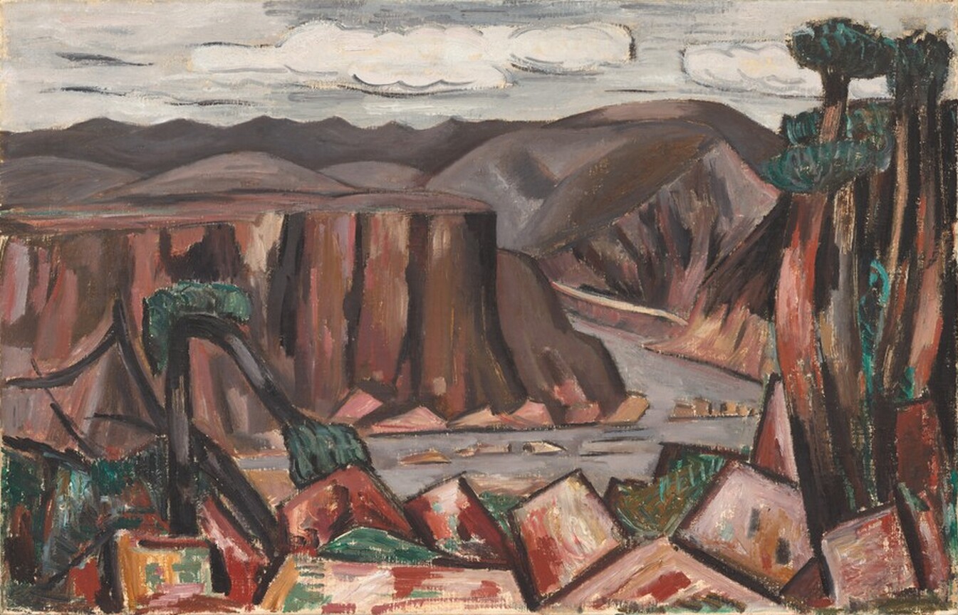 A steel-gray river separates blocky forms and trees across the bottom of this stylized landscape from sheer cliffs and mountains beyond in this horizontal painting. The blocky forms, perhaps abstracted boulders, close to us are painted with shades of maroon red, mauve pink, and terracotta orange. Trees with thin brown trunks and narrow tufts of green to suggest canopies grow up the right edge of the canvas, and a tree bows over to the left, presumably broken. Across the river, the flat-topped cliffs to the left and mountains beyond are painted with visible strokes in shades of brown with some highlights in dark rose pink. A silvery-gray sky with white clouds fills the top fifth of the composition.