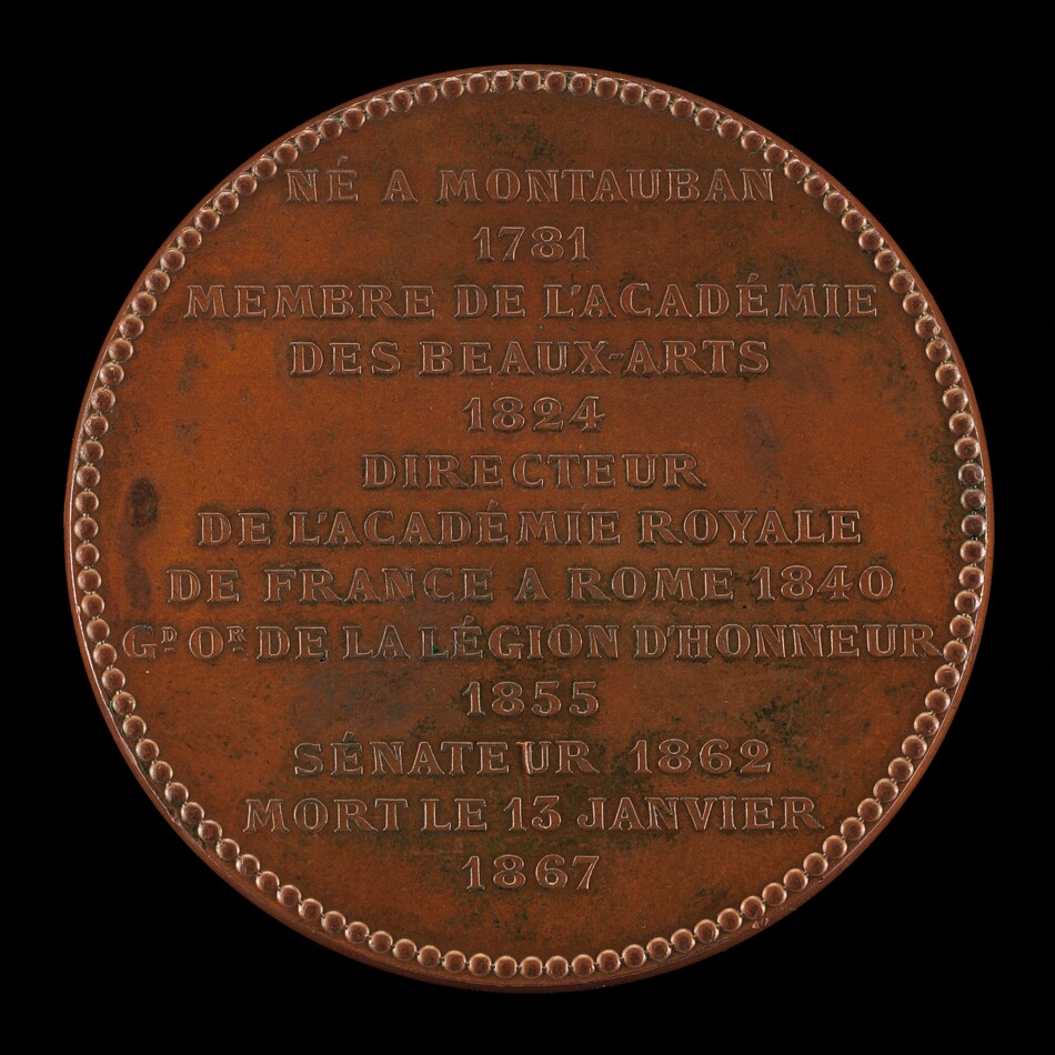 This is a photograph of a commemorative medallion. The medallion is inscribed with text in French detailing dates and accomplishments associated with an individual born in Montauban in 1781. The text mentions their membership in the Académie des Beaux-Arts in 1824, their role as Director of the Académie Royale de France in Rome in 1840, their status as a Grand Officer of the Légion d'Honneur in 1855, and their senatorial role in 1862. The medallion also marks their death on January 13, 1867. The edge of the medallion is decorated with a beaded border. The surface shows signs of aging, with patches of green patina suggesting oxidation typical for old bronze or copper alloys.